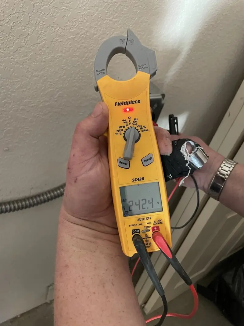 Voltage testing with clamp meter during Ceiling Fan Installation in Little Flock